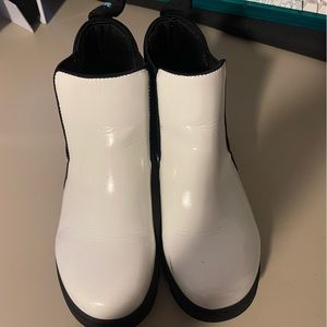 White Native boots.